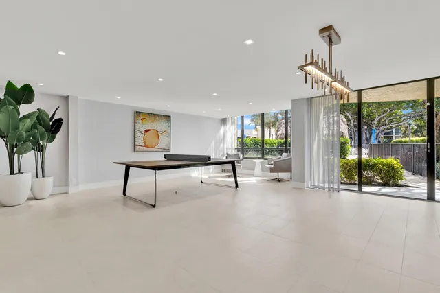a view of a patio with table and chairs and potted plants