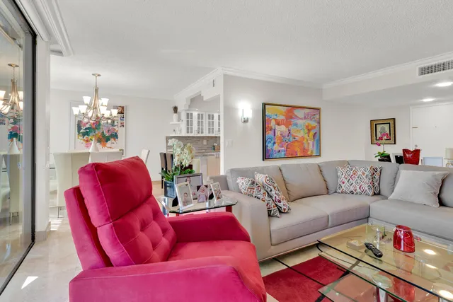a living room with furniture and a chandelier
