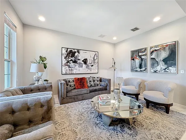 a view of a dining room with furniture and chandelier
