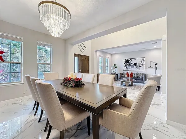 a kitchen with stainless steel appliances granite countertop a sink a counter space and a view of living room