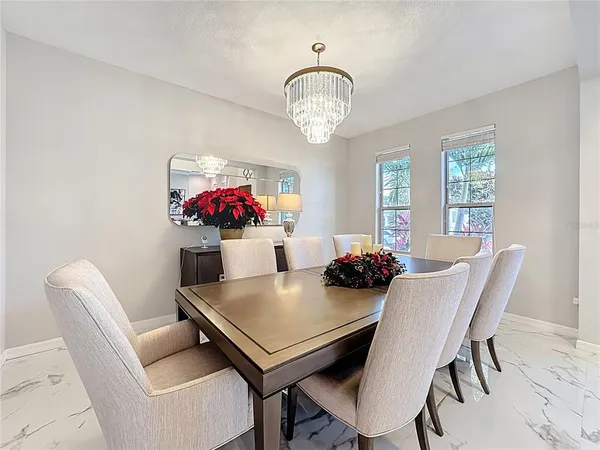 a kitchen with stainless steel appliances kitchen island a sink and a view of living room