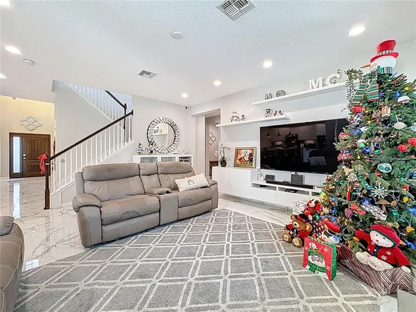 a kitchen with stainless steel appliances kitchen island granite countertop a stove a sink and a microwave