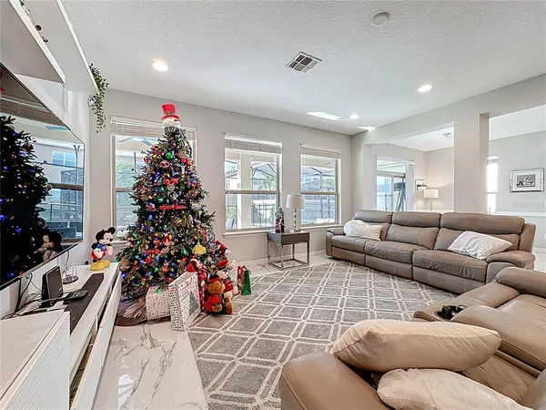 a kitchen with granite countertop a stove a microwave a sink and cabinets