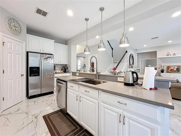 a bathroom with a granite countertop sink a toilet and a mirror
