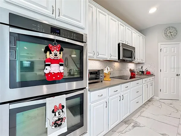 a room with furniture pool table and windows