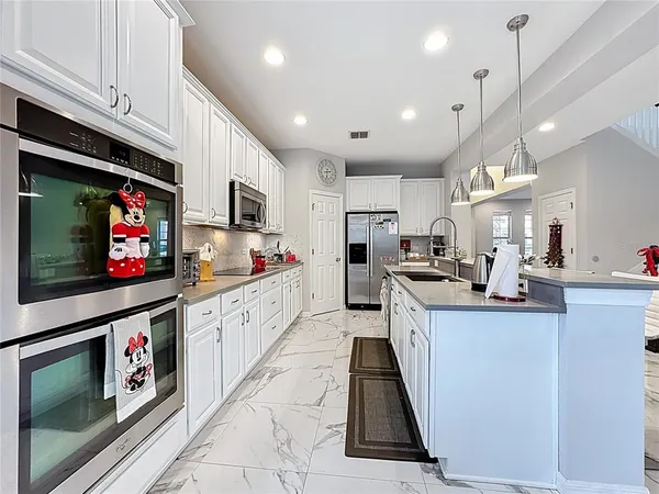 a living room with furniture pool table and a flat screen tv
