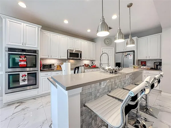 a room with furniture pool table and a window