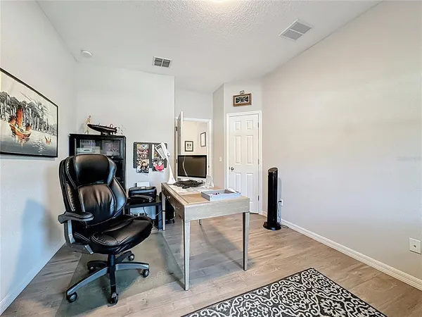 a spacious bedroom with a bed and window