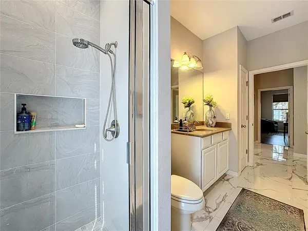 a view of a patio with a table and chairs under an umbrella