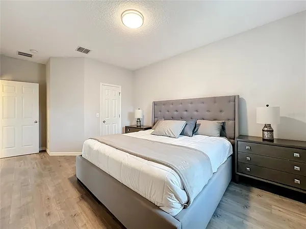 an aerial view of a house with a garden and lake view