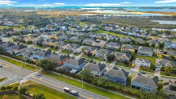 an aerial view of residential houses with outdoor space and parking
