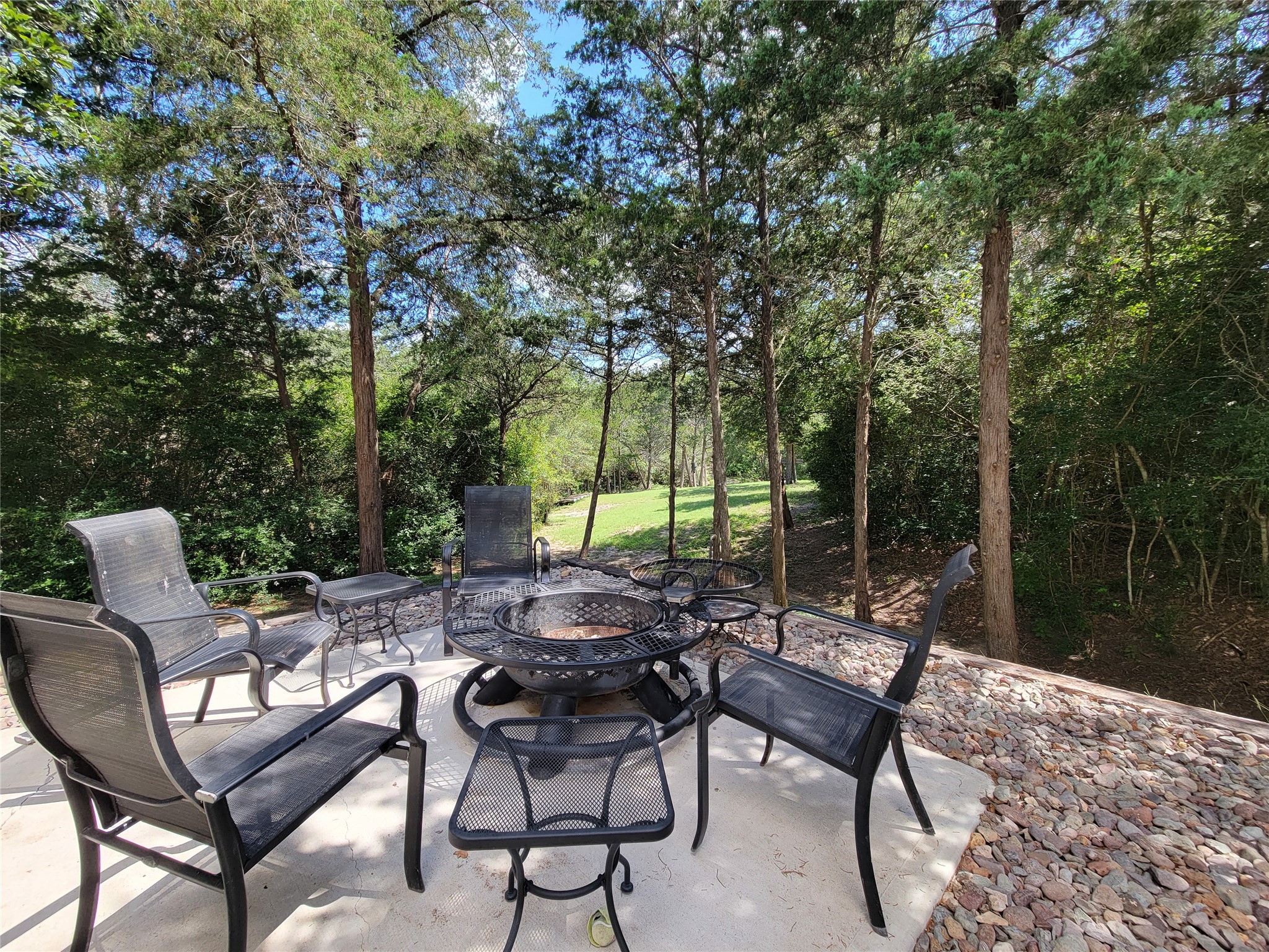 4937 Wolff Road Round Top, TX 78954 - Photo 7 of 31 Charming sitting area off the front patio with serene wooded views of the dry creek, perfect for stargazing nights.