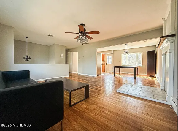 a living room with furniture and wooden floor