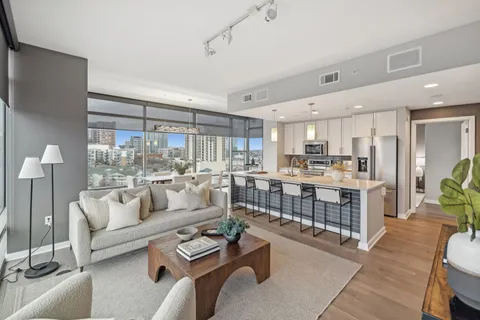 a living room with furniture and a large window