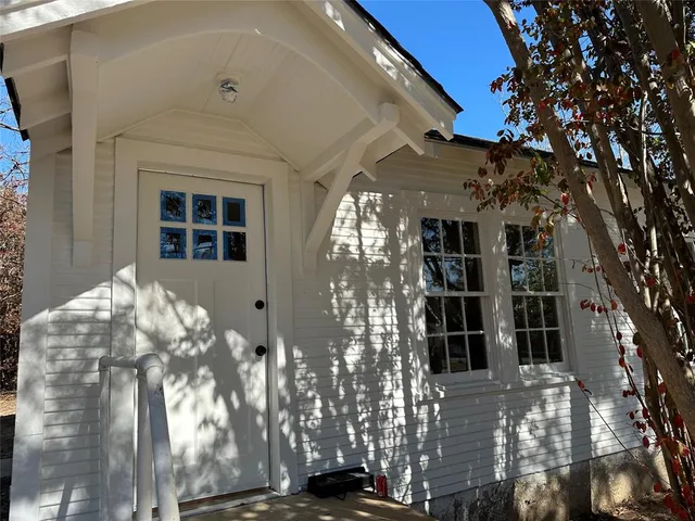 a view of a house with a tree