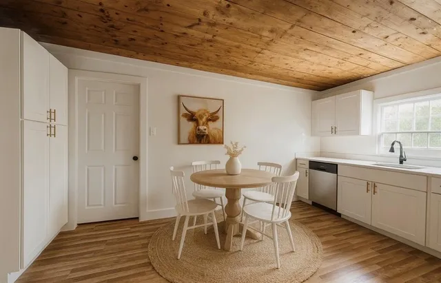 a kitchen that has a sink and chairs in it