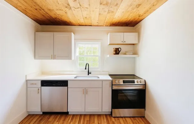 a kitchen with a sink stove and cabinets
