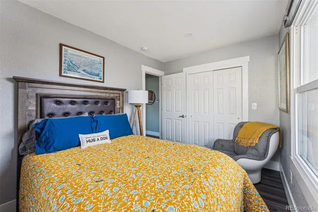 a bedroom with a bed a rug and a chair