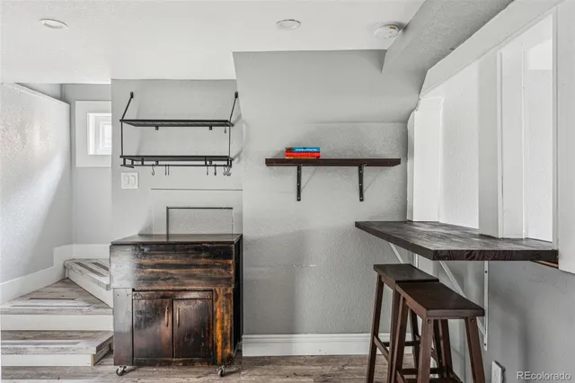a view of workspace with furniture and wooden floor