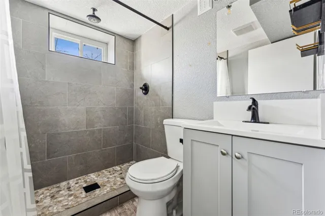 a bathroom with a sink toilet and shower