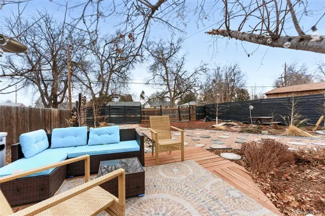 a view of a backyard with a bench and fire pit