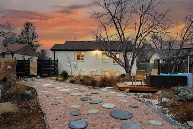 a backyard of a house with table and chairs