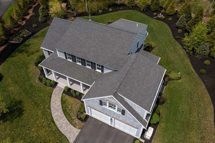 an aerial view of a house with garden space and street view