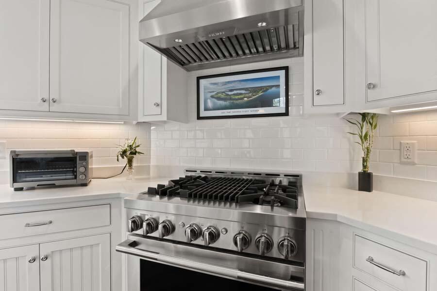 19 Bascom Hollow Harwich, MA 02645 - Photo 13 of 43 a kitchen with a stove and white cabinets
