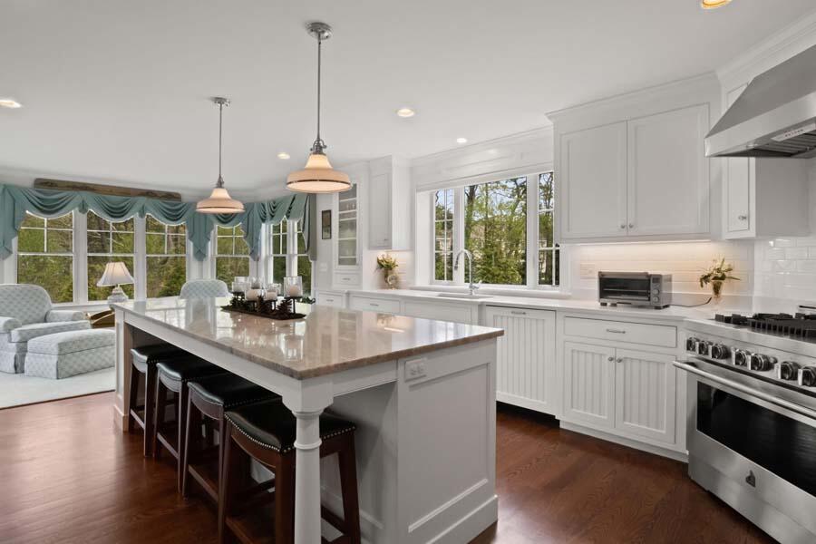 19 Bascom Hollow Harwich, MA 02645 - Photo 14 of 43 a kitchen with stainless steel appliances granite countertop a stove a sink dishwasher a refrigerator and white cabinets with wooden floor