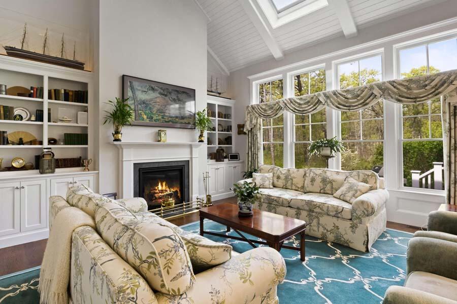 19 Bascom Hollow Harwich, MA 02645 - Photo 17 of 43 a living room with furniture a flat screen tv and a fireplace