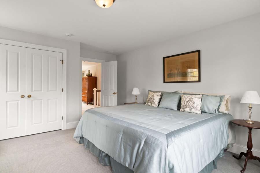 19 Bascom Hollow Harwich, MA 02645 - Photo 29 of 43 a bedroom with a bed and a painting on the wall