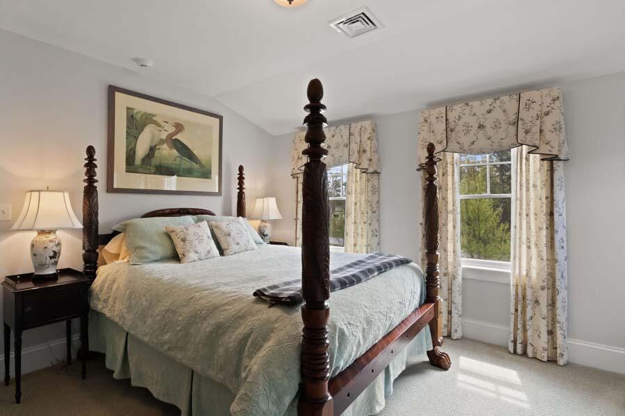 19 Bascom Hollow Harwich, MA 02645 - Photo 30 of 43 a bedroom with a bed and a painting on the wall