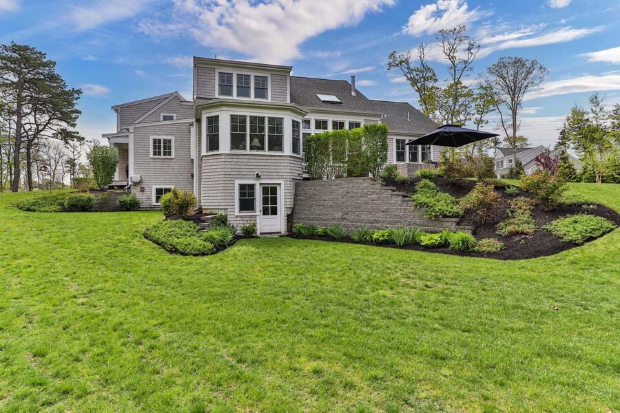 19 Bascom Hollow Harwich, MA 02645 - Photo 33 of 43 a front view of a house with a yard