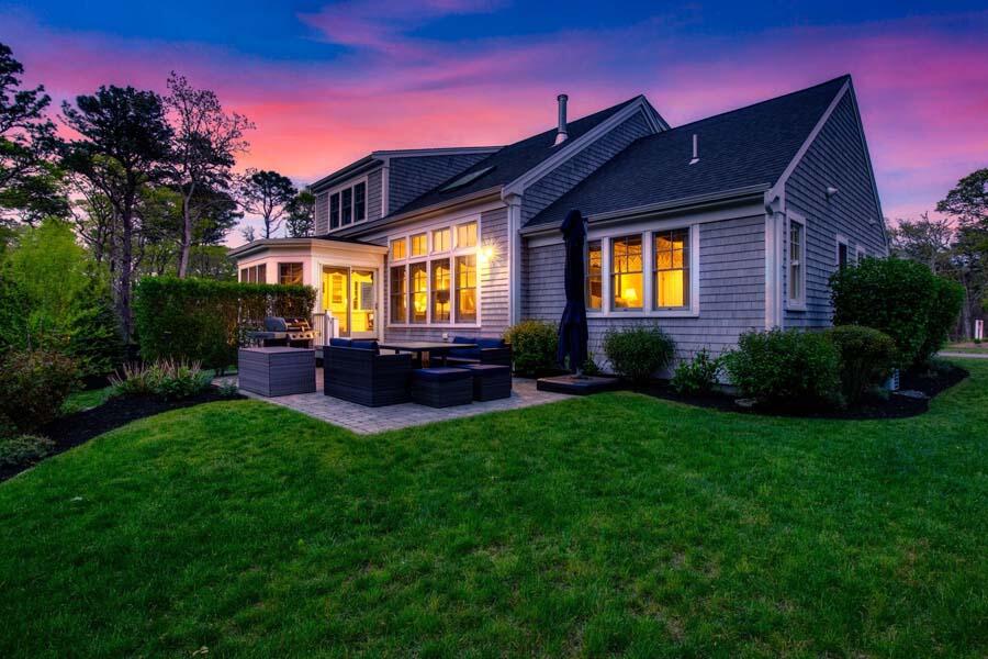 19 Bascom Hollow Harwich, MA 02645 - Photo 4 of 43 a backyard of a house with table and chairs
