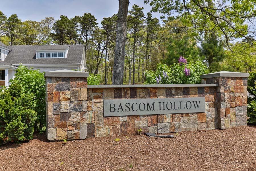 19 Bascom Hollow Harwich, MA 02645 - Photo 10 of 43 a street sign that is sitting on a brick wall