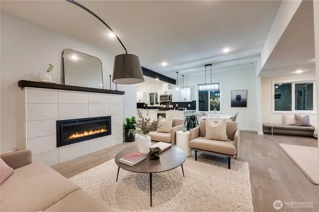 a living room with furniture a fireplace and a flat screen tv