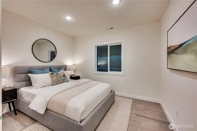 a bedroom with bed and a large mirror