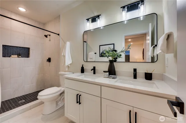 a bathroom with a toilet sink and mirror