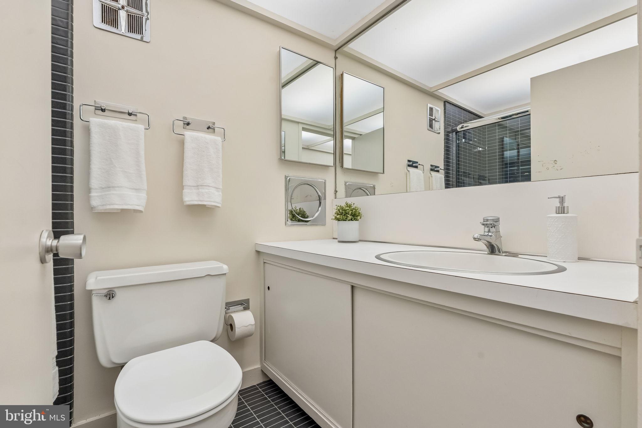1640 Monk Road Gladwyne, PA 19035 - Photo 18 of 41 a bathroom with a granite countertop toilet sink and mirror