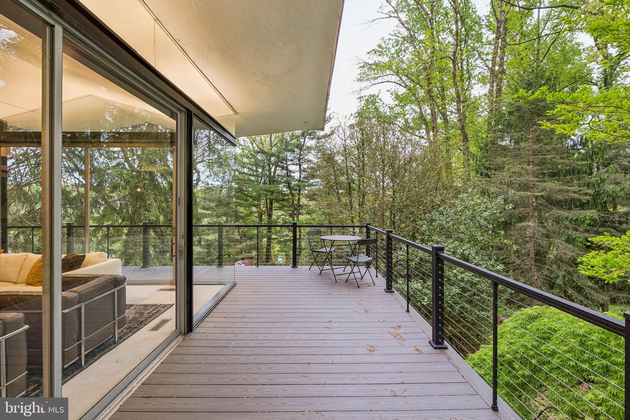1640 Monk Road Gladwyne, PA 19035 - Photo 20 of 41 a view of a balcony with wooden floor next to a iron stairs