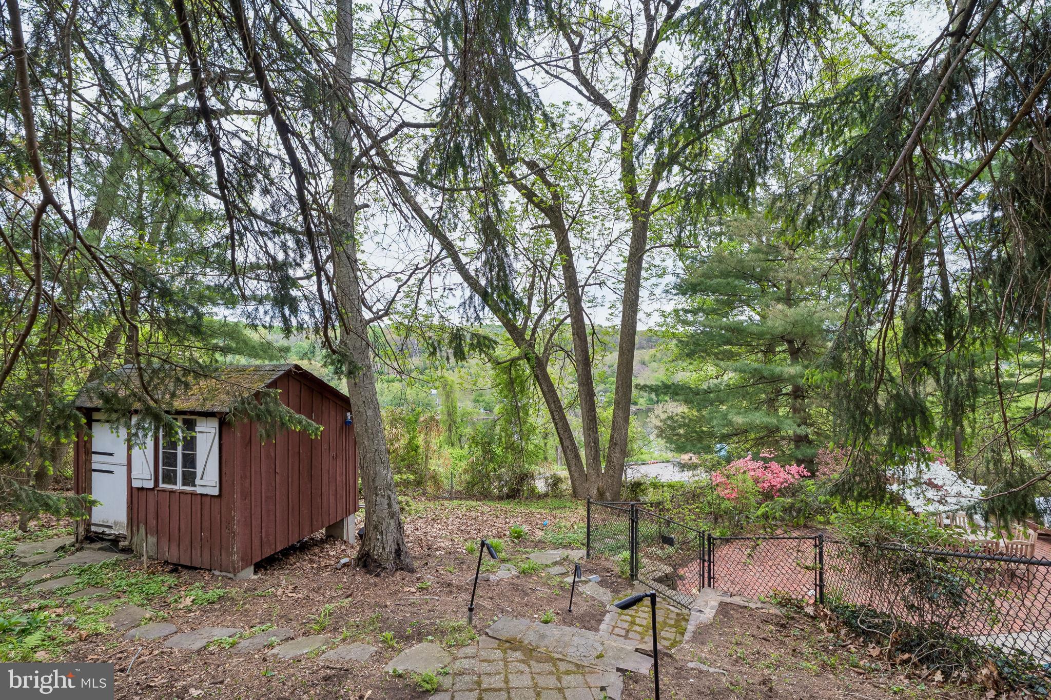 1640 Monk Road Gladwyne, PA 19035 - Photo 35 of 41 a view of a backyard with large trees and plants