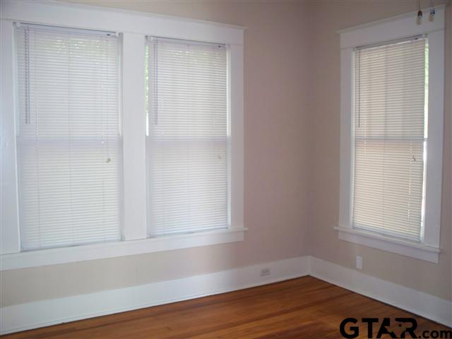 302 West Bryan Street Tyler, TX 75702 - Photo 3 of 7 a view of a small space with wooden floor and a window
