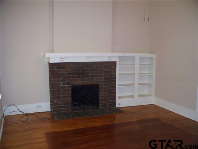 302 West Bryan Street Tyler, TX 75702 - Photo 5 of 7 a living room with a fireplace