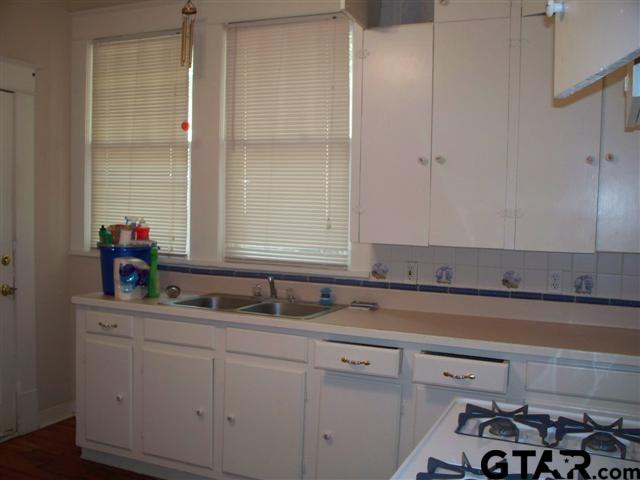302 West Bryan Street Tyler, TX 75702 - Photo 6 of 7 a kitchen with a sink and cabinets