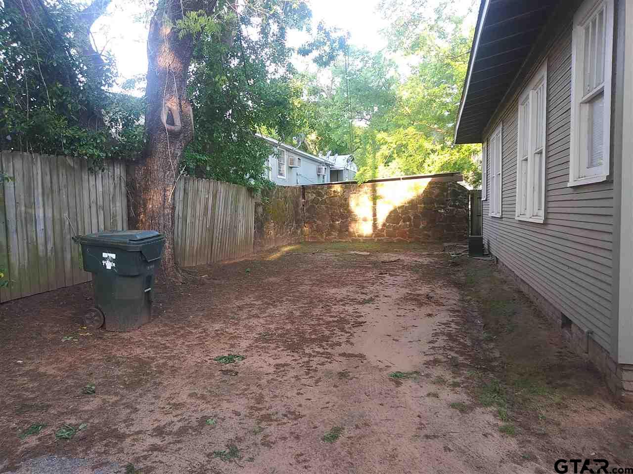 302 West Bryan Street Tyler, TX 75702 - Photo 7 of 7 a backyard of a house with lots of green space