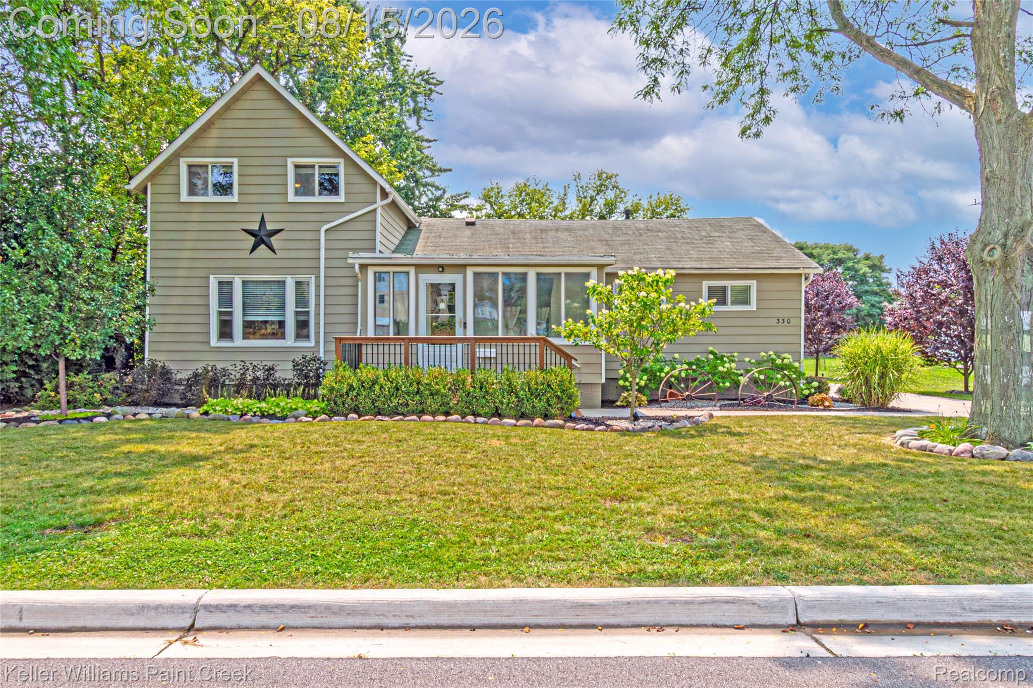 330 East Washington Street Romeo, MI 48065 - Photo 13 of 68 Gable-front home featuring a covered porch, wood deck, and established front landscaping