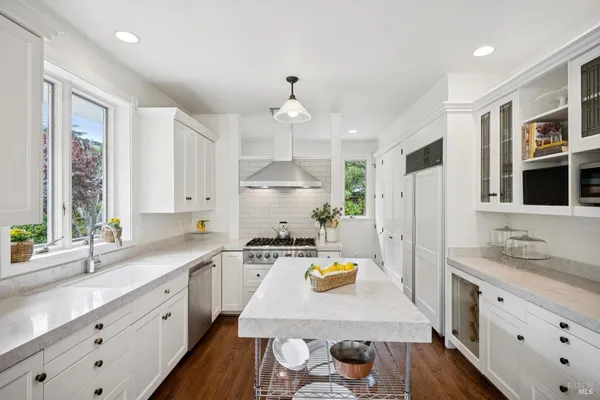 a kitchen with a large window and cabinets