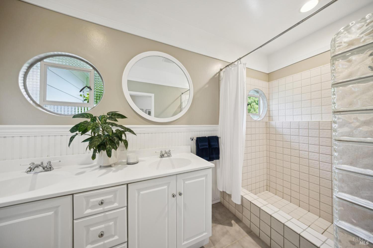 1199 Butterfield Road San Anselmo, CA 94960 - Photo 32 of 65 a bathroom with a sink a mirror a vanity and a shower