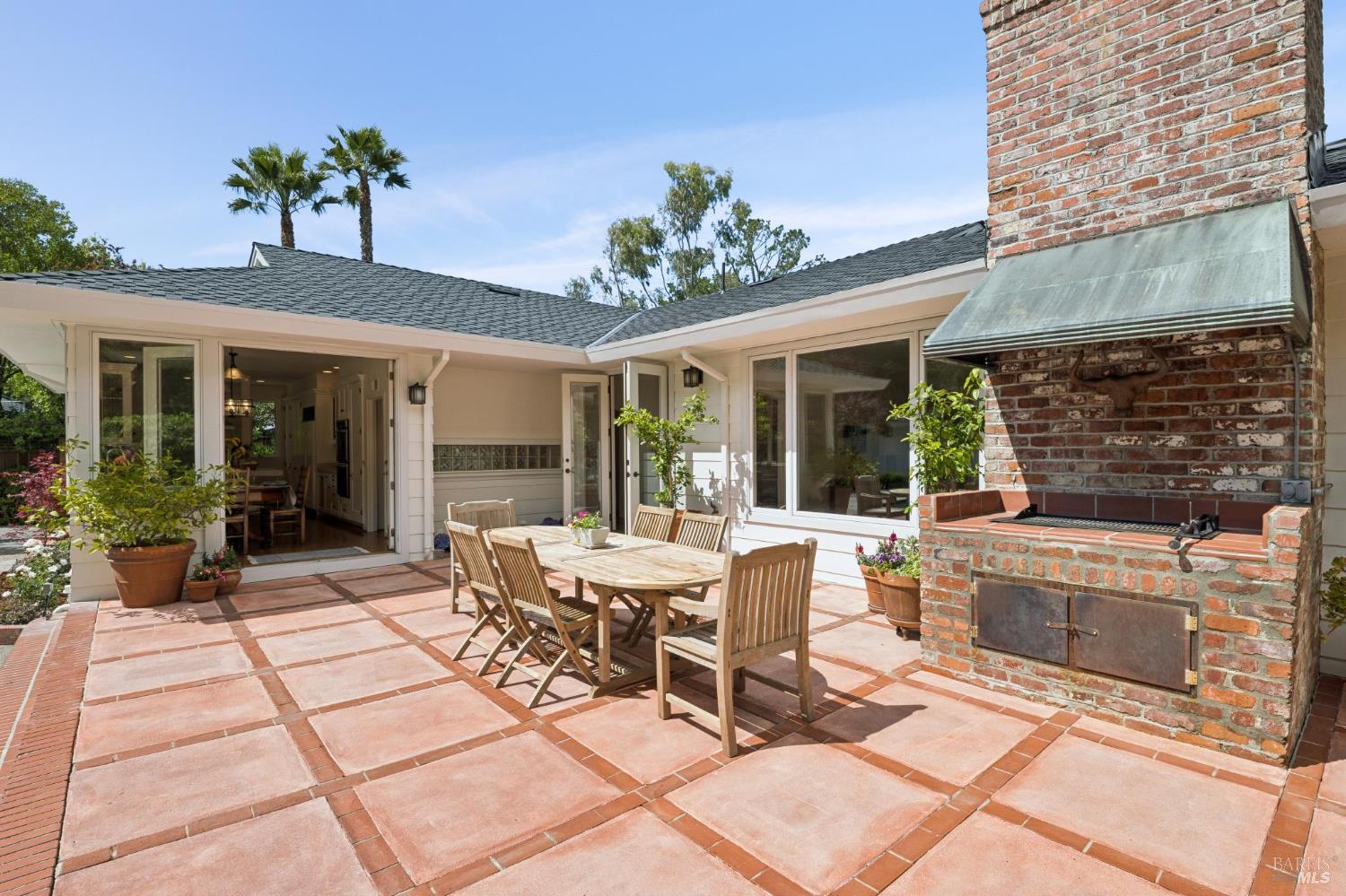 1199 Butterfield Road San Anselmo, CA 94960 - Photo 42 of 65 a view of a patio with table and chairs potted plants with wooden floor and fence