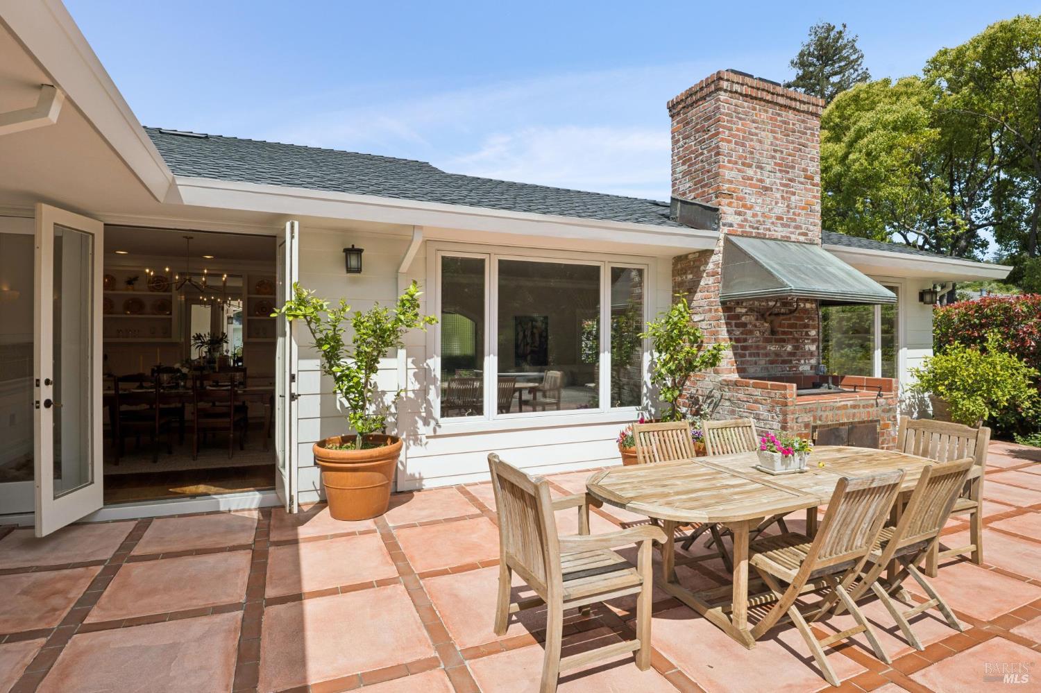 1199 Butterfield Road San Anselmo, CA 94960 - Photo 43 of 65 a patio with a table and chairs and potted plants